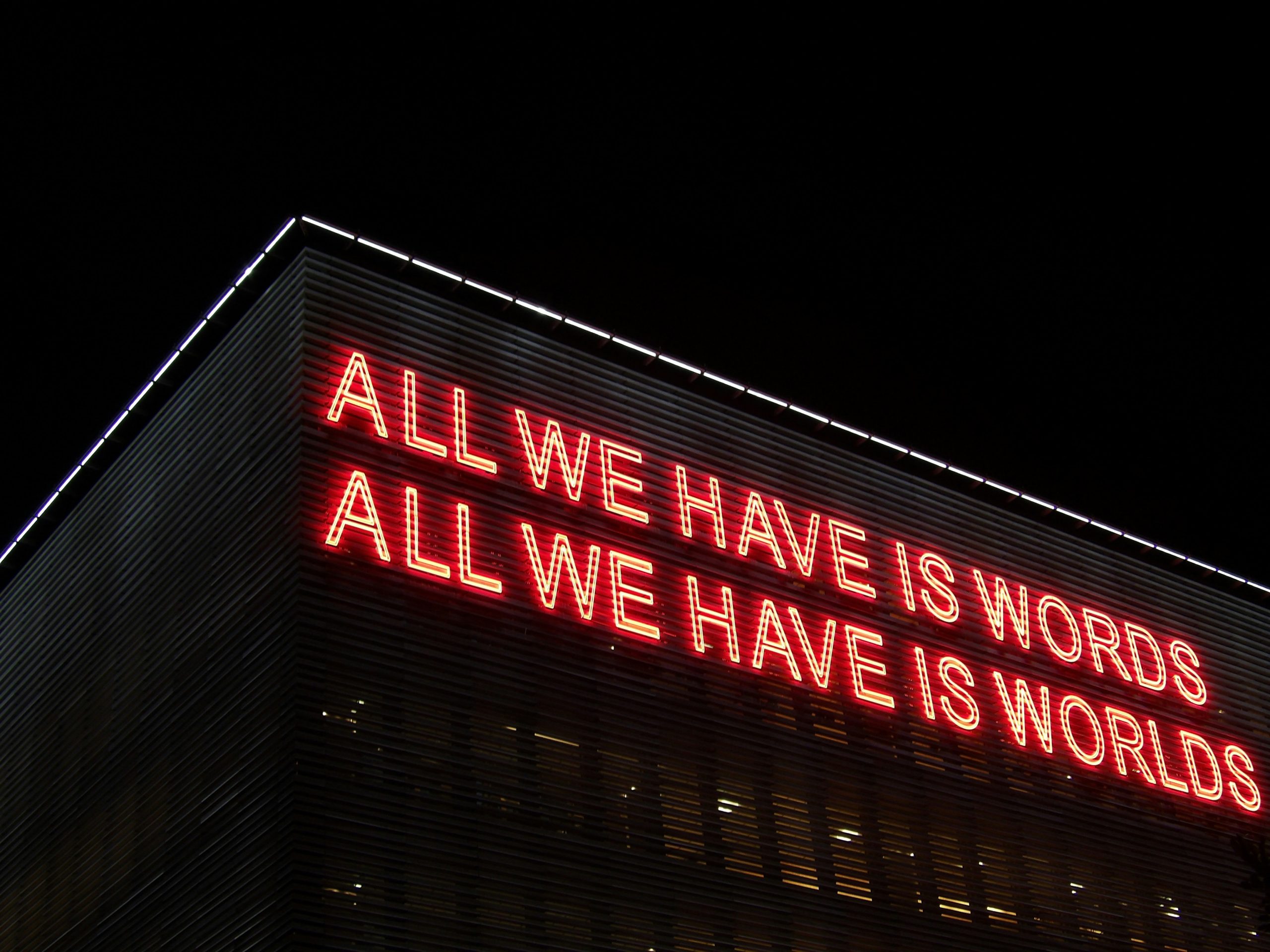 Word count. Quote in red lights "All we have is words. All we have is worlds."