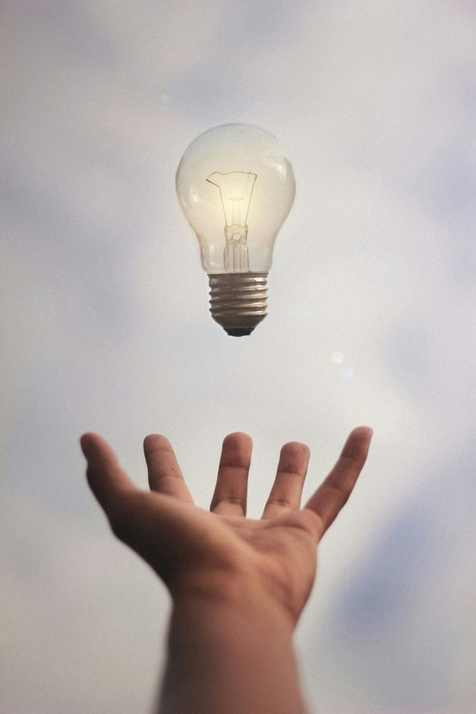 EEAT. Light bulb above an open hand
