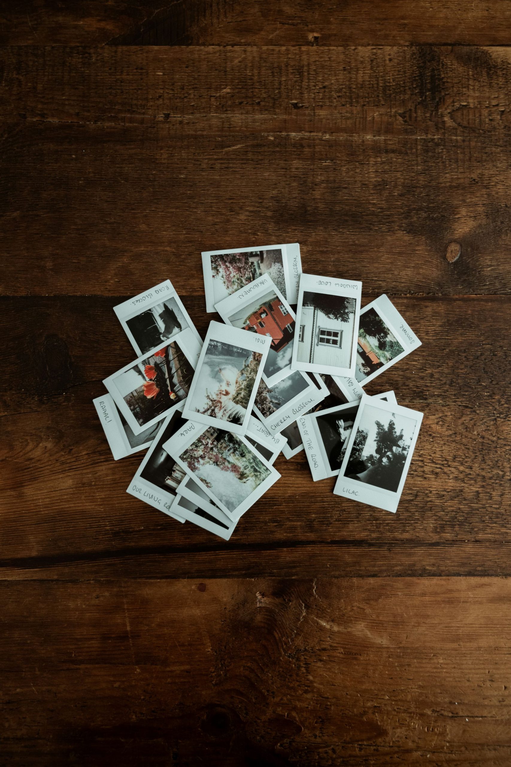Using images on your website represented by a pile of polaroid photos on a wooden floor