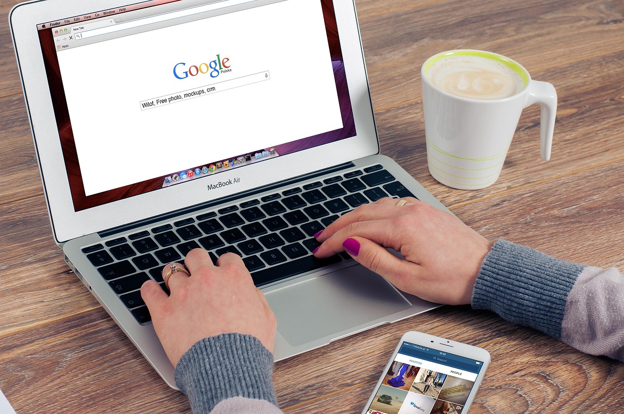 An open laptop and pair of woman's hands typing into a Google search bar which is what the Ranking & Romance workshop is all about